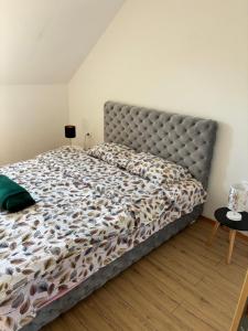 a bedroom with a large bed with a metal headboard at Apartman Brod in Konjska Reka