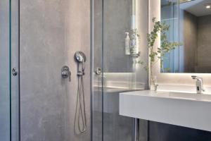 a bathroom with a shower and a sink at Acropolis Lumina in Athens +22 photos