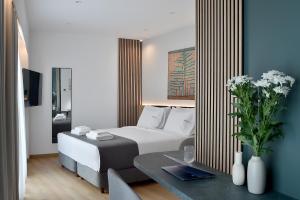 a hotel room with a bed and a table at Acropolis Lumina in Athens
