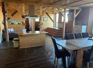 a living room with a wooden table and chairs at Ferien auf dem Pferdehof in Rappin