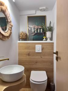 a bathroom with a white toilet and a sink at Ραστώνη in Tolo