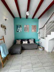 a room with two beds and a blue wall at Casa Gino in El Cotillo
