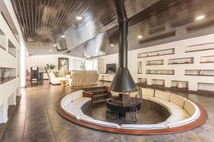 a living room with a fireplace in the middle of it at Casa da Palmeira in Sesimbra
