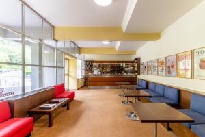 a restaurant with red and blue seats and tables at Dynamotel in San Marcello Pistoiese