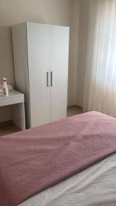 a bedroom with a bed and a white cabinet at Stellarium House in Vibo Valentia
