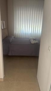 a bedroom with a bed and a window with towels at Stellarium House in Vibo Valentia