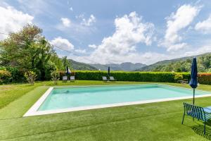 an image of a swimming pool in a yard at Dynamotel in San Marcello Pistoiese