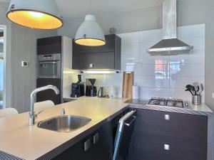 a kitchen with a sink and a counter top at Luxe Duinsuite in Groet +46 photos