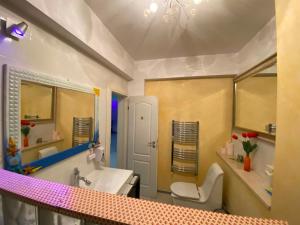 a bathroom with a sink and a toilet at RC RelaxApart 4 in Dudu +5 photos