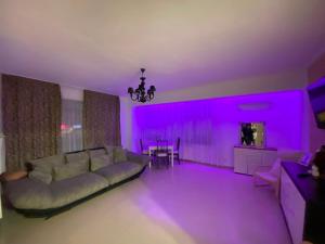 a living room with a couch and purple lighting at RC RelaxApart 4 in Dudu