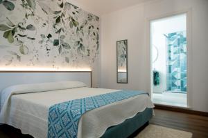 a bedroom with a bed and a large window at G&G Bed&Breakfast in Bonorva