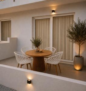 a dining room with a table and white chairs at Spitaki mou - 1bd house in Mastihari