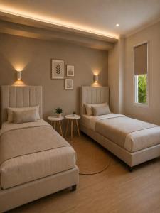 a bedroom with two beds and two tables at Spitaki mou - 1bd house in Mastihari