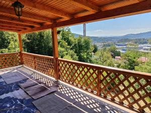 a deck with a view of the mountains at Villa NEOM, Sarajevo in Vogošća