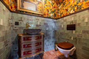 a bathroom with a sink and a toilet at Galuonu Vilos Vip vila in Inturkė