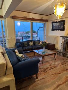 a living room with a couch and a table at Sourada Studios in Mytilene