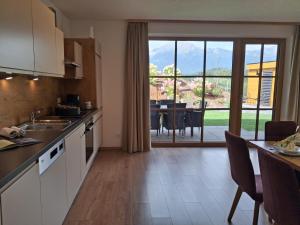 a kitchen with a view of a table and a dining room at Landhaus Eiter in Arzl im Pitztal +86 photos