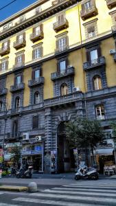 a large building with an archway in front of it at B&B Univercity in Naples