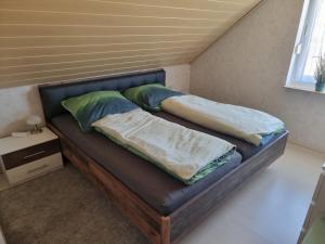 a bed with two pillows on it in a room at Ferienwohnung in Klein Düngen in Bad Salzdetfurth