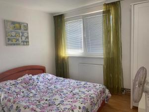 a bedroom with a bed and a window at XXL apartman Free parking in Visoko