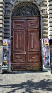 ナポリにあるB&B Univercityの大きな木製ドア(冷蔵庫2台付)