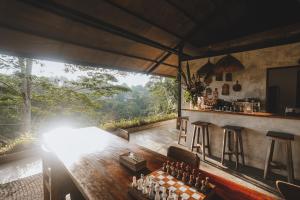 a large room with a table and a bar at The Hidden Paradise Ubud - CHSE Certified in Ubud