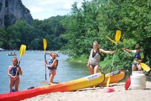 a group of people standing on a beach with boats at Camping Ushuaïa Villages Les Cruses in Ribes