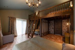 a large room with a staircase and a bedroom at Galuonu Vilos Vip vila in Inturkė