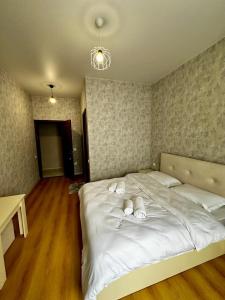 a bedroom with two beds with towels on them at HOTEL Old Boulevard BATUMI in Batumi +3 photos