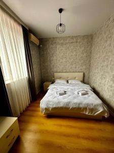 a bedroom with a white bed and a window at HOTEL Old Boulevard BATUMI in Batumi
