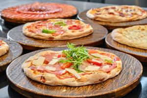 a group of pizzas on plates on a table at SPA Resort St Ivan Rilski - Halfboard & All Inclusive in Bansko