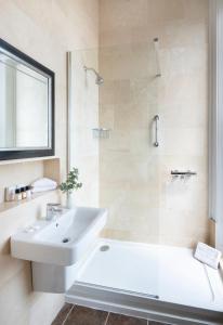 a bathroom with a white sink and a shower at Langham Hotel Eastbourne in Eastbourne +92 photos