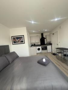 a bedroom with a bed and a table and a kitchen at CoolSideOfThePillow in Swindon +14 photos