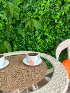 a table with two cups of coffee on it at HOTEL Old Boulevard BATUMI in Batumi