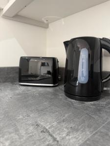 a toaster and a toaster sitting on a counter at CoolSideOfThePillow in Swindon