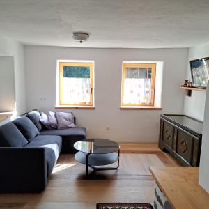 a living room with a couch and a table at "Hisel-Haus" in Techelsberg am Worthersee