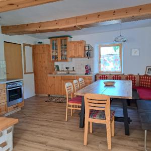 a kitchen with a dining room table and chairs at "Hisel-Haus" in Techelsberg am Worthersee
