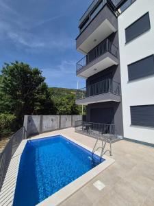 a house with a swimming pool next to a building at B&O Seaview in Bar