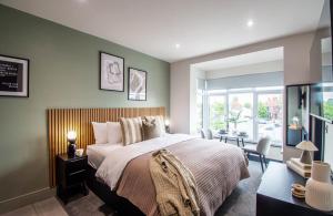 a bedroom with a large bed and a large window at The Mariner's Rest Aparthotel in Cleethorpes