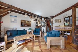a living room with blue couches and a table at Chalet La Grange Courchevel in Courchevel