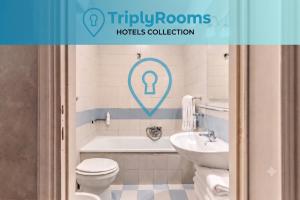 a bathroom with a tub and a toilet and a sink at TriplyRooms Collection - Roma Colosseo in Rome +1 photo
