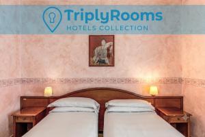 two beds in a room with a sign that reads triple rooms at TriplyRooms Collection - Roma Colosseo in Rome