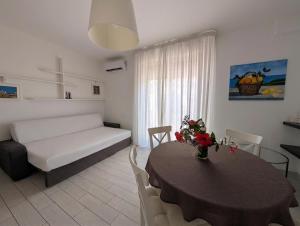 a living room with a table and a couch at Attico al Centro in Cefalù