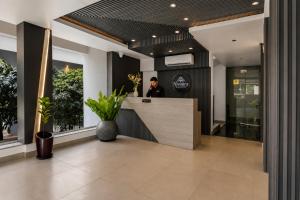 a man standing at the counter of a restaurant at Nivaara by GHD Hotels in Nerul +18 photos