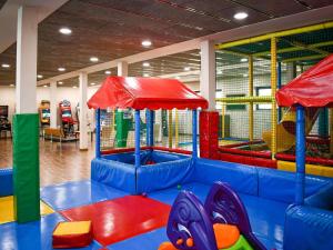 a play room with a playground with colorful equipment at Mercure Andorra in Andorra la Vella