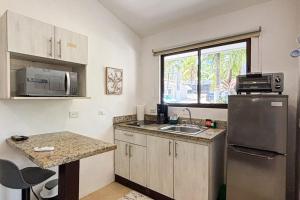 a small kitchen with a sink and a refrigerator at Club Voca 8 in Coco +10 photos