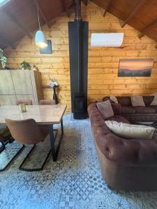 a living room with a couch and a table at Chalet 9 La Boverie in Rendeux +56 photos