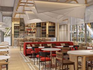 a restaurant with tables and chairs and a bar at Domaine des Grands Sables, Île Groix - Handwritten Collection in Groix