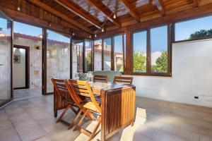 a dining room with a wooden table and chairs at Dal Cappellaio Matto in Taranto