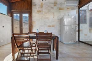 a kitchen with a table and chairs and a refrigerator at Dal Cappellaio Matto in Taranto +14 photos